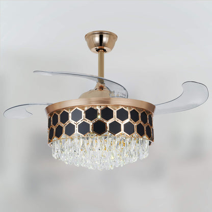 A view of the gold ceiling fan, with transparent blades above its crystal chandelier light.
